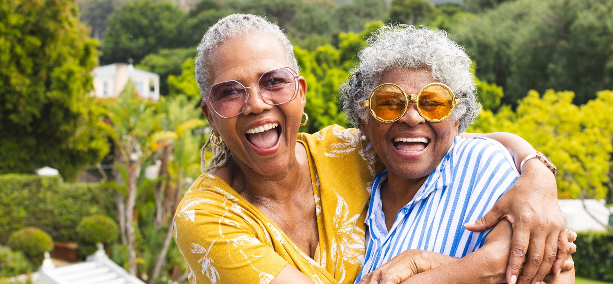 Two women smiling confidently with their dentures in Lincoln Park