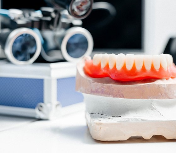 Lower dentures sitting on a mouth mold