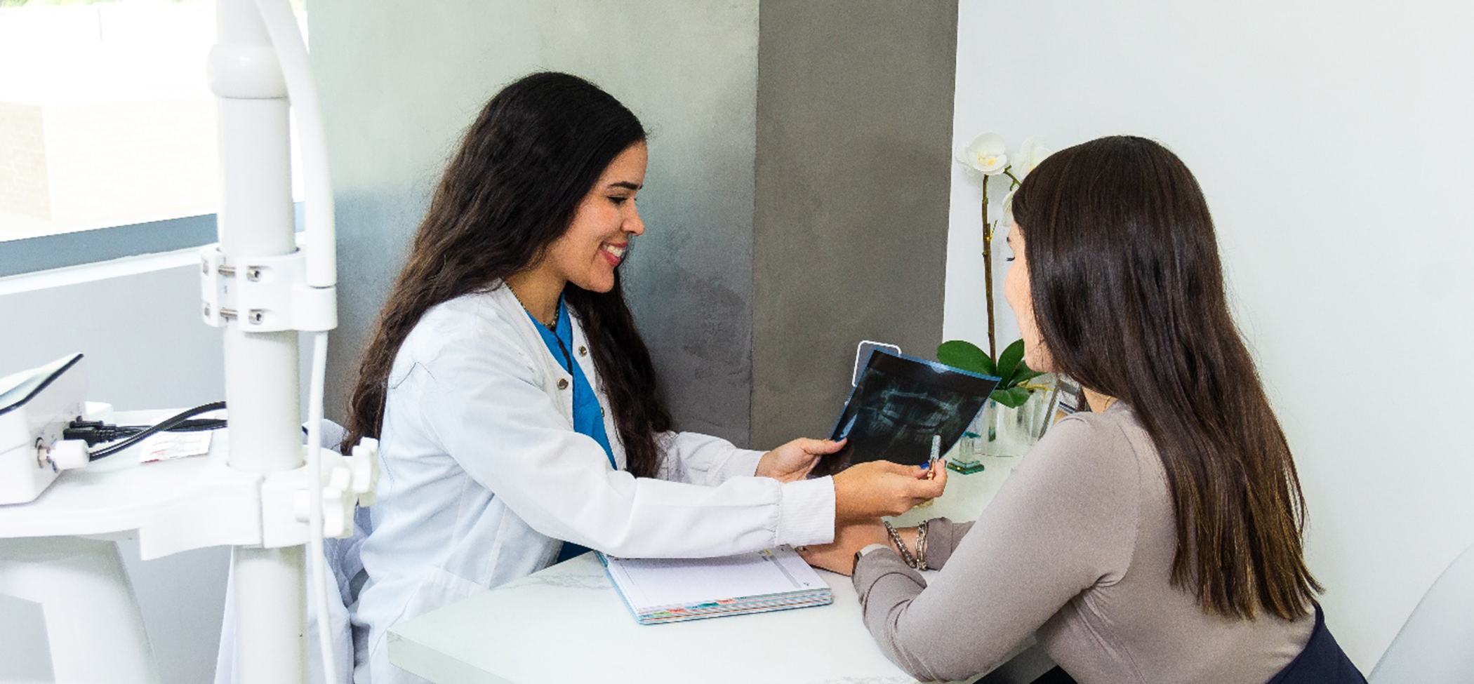 Dentist discussing TMJ treatment in Lincoln Park to female patient