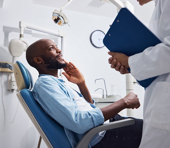 Male patient listening to dentist discuss treatment options