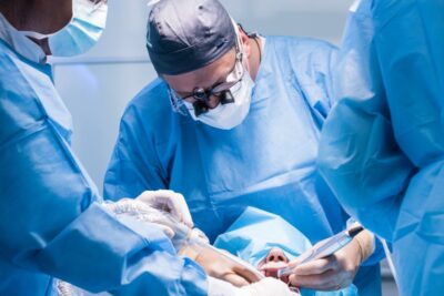 Dentists performing dental implant surgery.