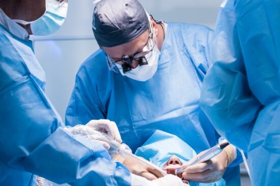 Dentists performing dental implant surgery.