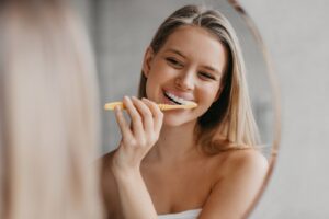 young woman brushing her teeth