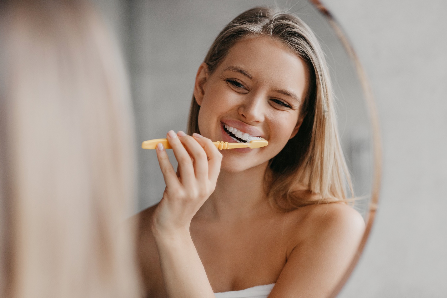 Young woman brushing her teeth.